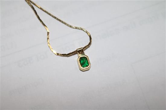 A gold, emerald and diamond pendant on a 14ct gold chain and a pair of similar gold, emerald and diamond ear studs.